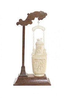 A Chinese Suspended Carved Ivory Vessel, Length of ivory hanging 10 1/8 inches.