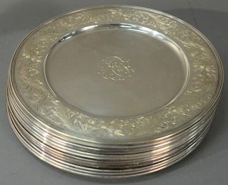 Set of twelve sterling silver service plates with chased floral borders (monogrammed, slightly used).   diameter 10 inches, 1