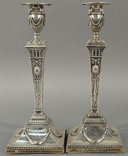 Pair of English silver candlesticks on square bases having wood bases, John Schofield 1779.   height 12 3/4 inches