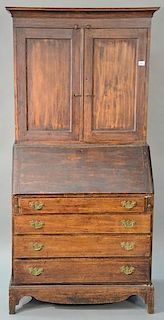 Country secretary desk in three parts, upper portion with two blind doors over slant lid over four drawers set on seperate ba