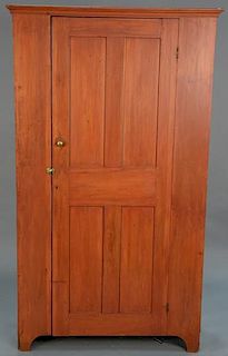 Primitive cupboard with one paneled door on cut out bracket feet, late 18th to early 19th century. 
height 78 inches, width 4