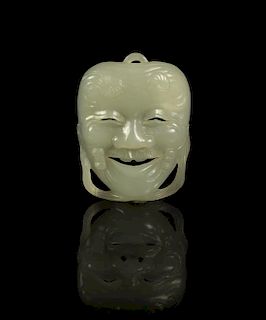 A Jade Miniature Okina Mask, Height 1 7/8 inches.