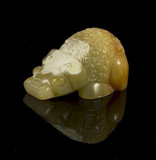 An Archaistic Jade Toggle of a Beast, Width 1 7/8 inches.