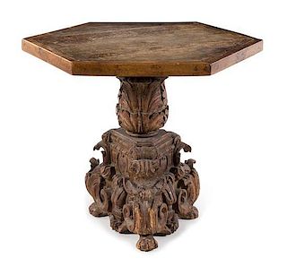 * An Italian Baroque Carved Walnut Center Table Height 32 x width 34 1/8 x depth 34 1/8 inches.