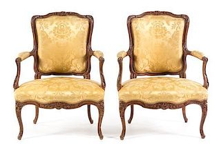A Pair of Louis XV Style Walnut Fauteuils Height 36 inches.