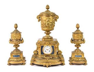 A Louis XVI Style Lapis Lazuli Inset Gilt Bronze Clock Garniture Height of mantel clock 23 3/4 inches.