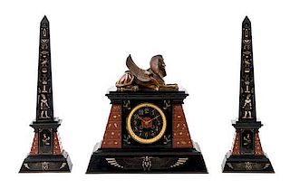 A French Egyptian Revival Three-Piece Clock Garniture Height of obelisk 20 1/4 inches.