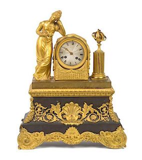 * A French Gilt and Patinated Metal Figural Mantel Clock Height 18 5/8 inches.