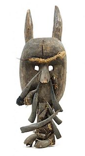 * A Toma Wood and Boar's Tusk Mask Height 28 inches.