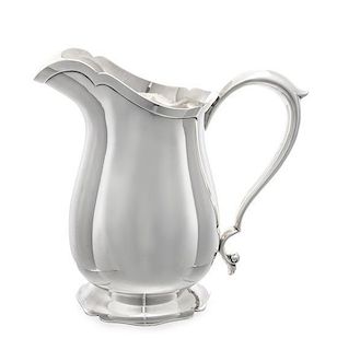An American Silver Water Pitcher, Ellmore Silver Co., Meriden, CT, the lobed baluster form body raised on a scalloped foot.