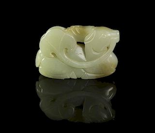 A Carved Celadon Jade Toggle, Width 2 3/4 inches.