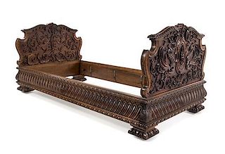 A Renaissance Revival Carved Walnut Bed Height of headboard 35 1/2 inches.