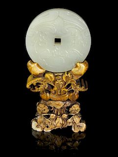 A Carved Jade Disc, Diameter 2 1/8 inches.
