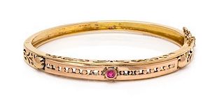 A 14 Karat Bicolor Gold and Ruby Simulant Bangle Bracelet, 12.10 dwts.