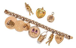 A 14 Karat Yellow Gold Bracelet with 7 Attached and 3 Unattached Charms, 72.00 dwts.
