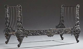 Cast Iron Continental Style Daybed, 20th c., the sleigh ends with relief floral and lion head decoration, joined by curved sp