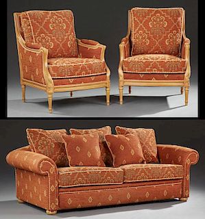 Three Piece Louis XVI Style Carved Beech Parlor Suite, 20th c., consisting of two bergeres and a settee, the bergeres with re
