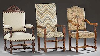 Group of Three French Louis XIII Style Fauteuils, early 20th c., consisting of an oak example with an arched crest and floret