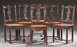 Set of Six Henri II Style Walnut Dining Chairs, 19th c., the carved arched crest rail flanked by acorn finials, above a pierc
