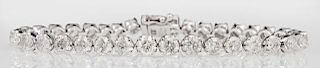 14K White Gold Tennis Bracelet, each of the 37 links mounted with a round diamond, total diamond weight- 9.39 cts., L.- 7 3/8