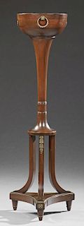 Regency Style Carved Mahogany Jardiniere, 20th c., the circular top with a copper insert and three side folding ring handles,