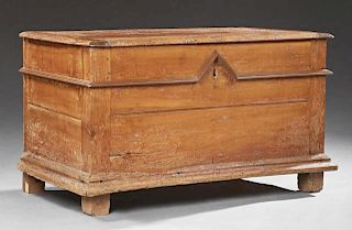 French Provincial Carved Cherry Coffer, early 19th c., the rounded edge lid over a base with applied stepped molding on a slo
