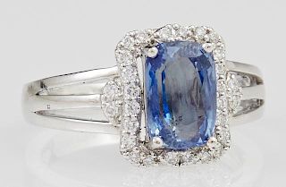 Platinum Diamond and Sapphire Dinner Ring, with a 3.04 carat cushion cut blue sapphire, atop a waisted border of small round 