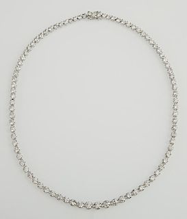 Platinum Diamond Tennis Necklace, each of the eighty-six links with a graduated round diamond, total diamond weight- 17.25 ct