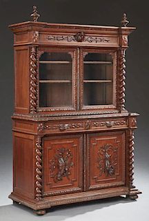 French Jacobean Style Carved Oak Buffet a Deux Corps, 19th c., the broken arch crown above double setback glazed doors flanke