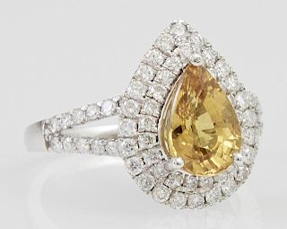 Lady's Platinum Dinner Ring, with a pear shaped 2.54 carat yellow sapphire atop a conforming double graduated concentric bord