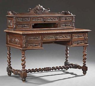 French Henri II Style Oak Writing Table, late 19th c., the arched carved crest over a back fitted with six drawers and open s