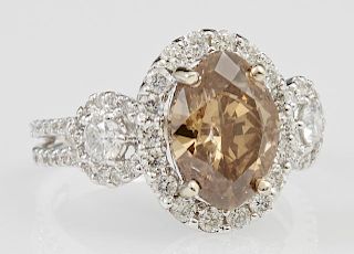 Lady's 18K White Gold Dinner Ring, with an oval natural fancy brown 2.52 carat diamond, atop a border of small round diamonds