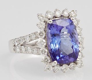 Lady's Platinum Dinner Ring, with a 6.26 carat cushion cut tanzanite atop a border of round diamond "points," on a split side