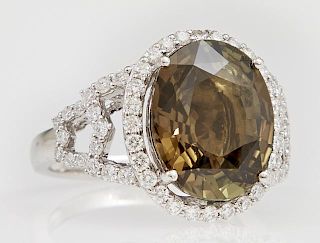 Lady's Platinum Dinner Ring, with an oval 6.61 carat alexandrite atop a border of round diamonds, flanked by pierced diamond 