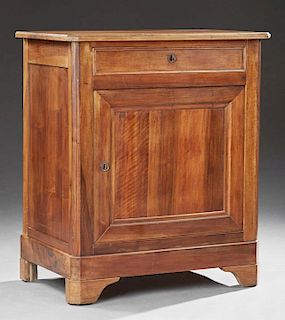 French Louis Philippe Carved Walnut Confiturier, c. 1850, the canted corner ogee edge top over a frieze drawer above a large 