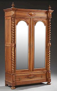 French Henri II Style Carved Walnut Armoire, c. 1880, the stepped break front finialed crown over setback arched wide beveled