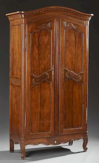 Diminutive French Carved Walnut Armoire, 19th c., the stepped arched top over arched panel double doors with iron fiche hinge