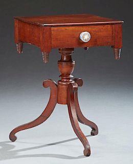 American Classical Style Carved Mahogany Lamp Table, 19th c., the square top over a single drawer with a glass knob above bee