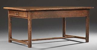 French Provincial Carved Oak Farmhouse Table, 20th c., the rectangular plank top over a wide skirt with a frieze drawer at bo