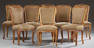 Set of Eight French Louis XV Style Upholstered Carved Beech Dining Chairs, 20th c., the arched highbacks to upholstered bowed