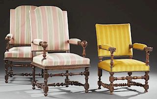 Pair of French Louis XIII Style Carved Walnut Fauteuils, 20th c., the arched upholstered backs over upholstered arms on turne