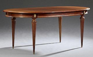Louis XVI Style Carved Mahogany Ormolu Mounted Dining Table, 20th c., the stepped oval top over a wide skirt, on turned taper