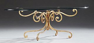 French Glass and Wrought Iron Coffee Table, 20th c., the thick oval beveled edge top on a gilt scrolled wrought iron base on 