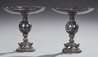Pair of Black Marble and Bronze Compotes, 20th c., the figured black marble tops on bronze socle supports on a black marble o