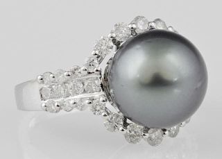 Lady's 18K White Gold Dinner Ring, with a 12 mm black Tahitian cultured pearl, atop a border of round diamonds, the shoulders