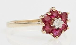 Lady's 14K Yellow Gold Floriform Dinner Ring, with a central round diamond flanked by 6 small round 10 point rubies, total ru