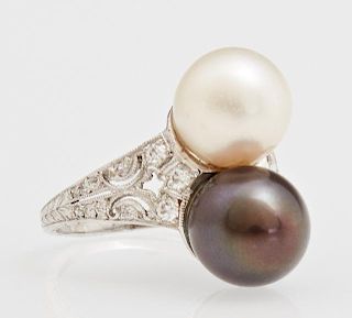 Lady's 18K White Gold Dinner Ring, with 9 mm white and black pearls, flanked by a tapering pierced band mounted with small ro
