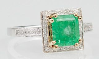 Lady's 14K White and Yellow Gold Dinner Ring, with a 2.07 carat cushion cut emerald atop a border of tiny round diamonds, the