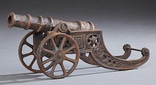 Cast Iron Scale Model of a Cannon, 20th c., with a sled-form pierced carriage, the rear of the barrel with a relief "S," H.- 