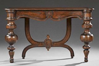 Continental Style Carved Mahogany Console Table, 20th c., the stepped cookie corner top on large turned tapered front legs, a